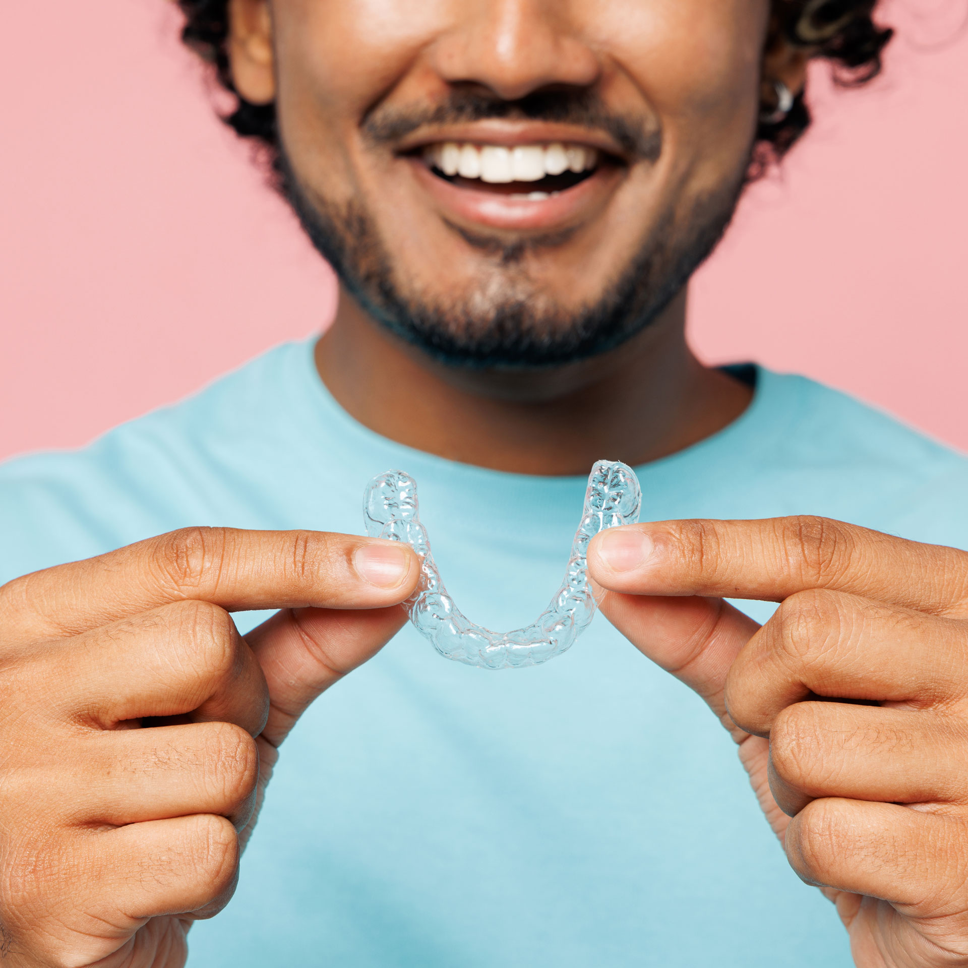 person holding braces for their orthodontist treatment